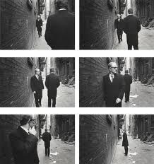 black and white photographs of men in suits walking down the street, talking on their cell phones