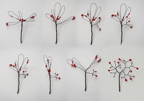 six different types of wire flowers with red berries on the stems and in the middle