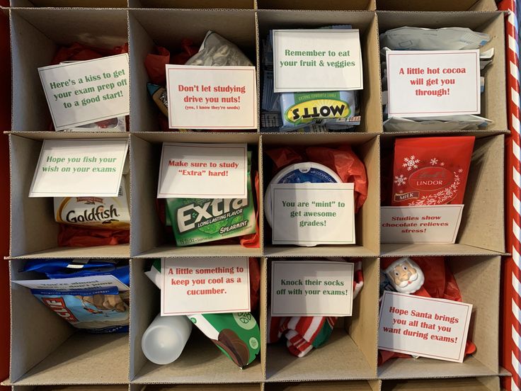 a cardboard box filled with different types of food and cards on the inside of it