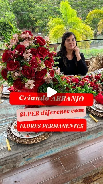 a woman sitting at a table with flowers on it