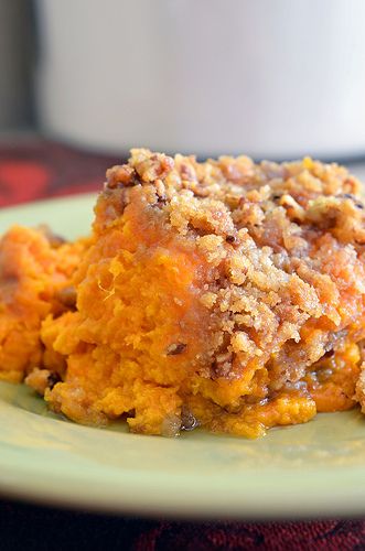 a close up of a plate of food with sweet potato casserole on it