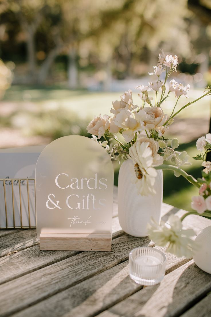 a table with flowers and cards on it