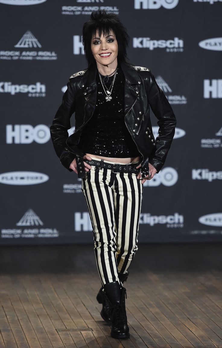 a woman in black jacket and striped pants