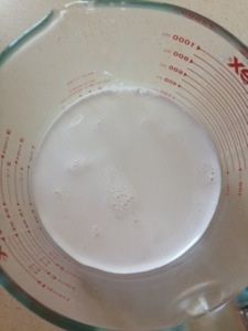 a glass measuring cup filled with white liquid