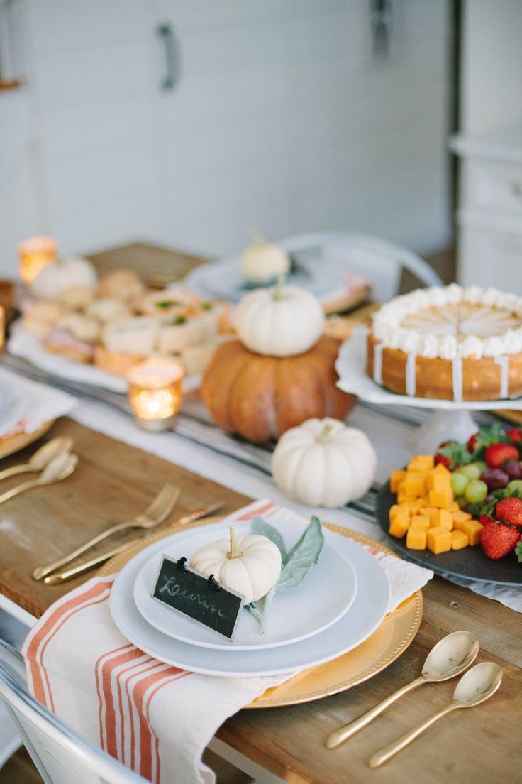 a table topped with lots of food and plates filled with cake on top of it