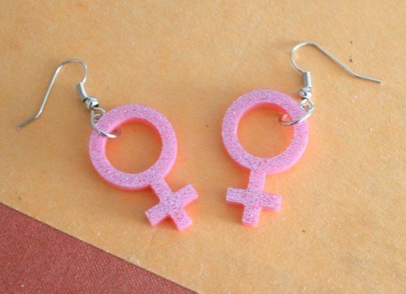 pink earrings with an image of the female symbol