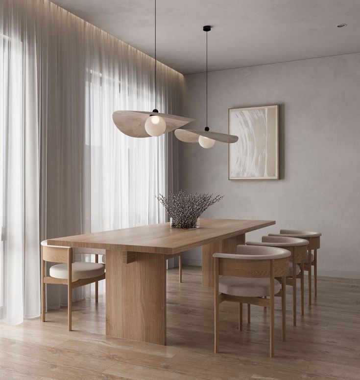 a dining room table with four chairs and a vase on the table next to it