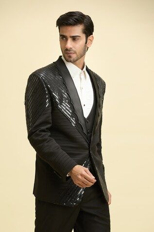 Black full sleeves shawl lapel tuxedo with tonal sequin tape embellishments and pintex detailing. Paired with a waistcoat and a quilted yoke shirt. - Aza Fashions Designer Formal Sets With Mirror Work, Embellished Traditional Drape Sherwani For Party, Formal Fitted Bandhgala With Mirror Work, Black Sequined Sherwani For Party, Black Sherwani With Mirror Work For Party, Party Black Sherwani With Mirror Work, Long Sleeve Sherwani With Sequins For Party, Long Sleeve Sequined Sherwani For Party, Long Sleeve Party Sherwani With Sequins