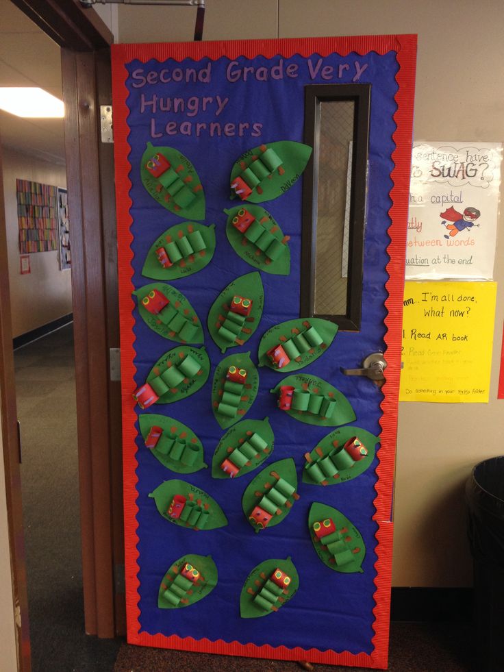 a classroom door decorated with green leaf shapes