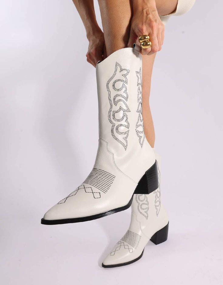 Here to stay, cowboy boots are a wardrobe staple. Designed with a vintage inspired stitching these beauties will make any outfit feel elevated and cool. Lined in neoprene they are so comfy you are going to be living in these boots. - Vicson Tip: Pairs perfectly with denim shorts and oversized jackets, or for a more night look we love them with leather. - 100% Leather - Made in Brazil - Runs true to size - We Recommend sizing up if in between sizes White Heeled Boots For Rodeo In Fall, White Heeled Boots For Fall Rodeo, White Mid-calf Boots For Rodeo In Fall, White Mid-calf Boots For Fall Rodeo, White Casual Boots For Rodeo, Casual White Boots For Rodeo, White Western Heeled Boots For Fall, Fitted White Leather Mid-calf Boots, White Leather Fitted Mid-calf Boots