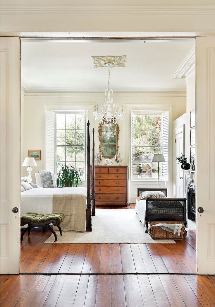 a bedroom with hardwood floors and white walls