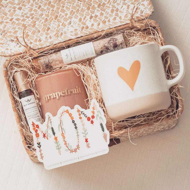 a gift box containing a coffee mug, lip balm and other personal care items