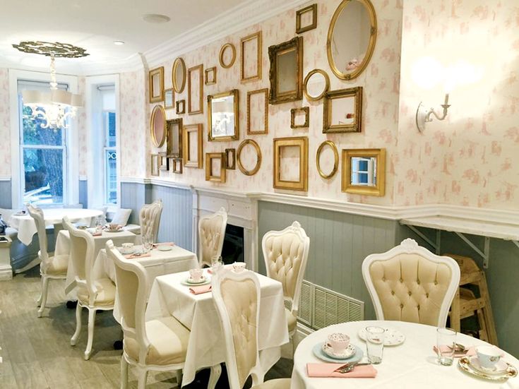 a dining room filled with white tables and chairs