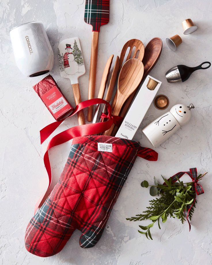 the kitchen utensils are laid out on the counter next to the red plaid oven mitt