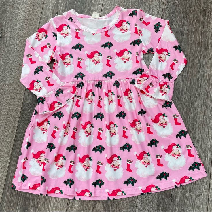 Girls Pink Christmas Dress With Santa Print. Pink Christmas Dress For Dress-up, Long Sleeve Christmas Dress For Dress-up, Cute Long Sleeve Holiday Dress For Festive Occasion, Cute Long Sleeve Festive Holiday Dress, Long Sleeve Holiday Dress For Christmas, Playful Long Sleeve Christmas Dress, Playful Christmas Party Dresses, Cute Long Sleeve Christmas Holiday Dress, Cute Long Sleeve Holiday Dress For Party