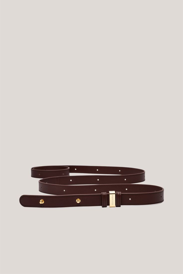 Discover the Double Wrap Belt, a sophisticated accessory designed for both functionality and style. This belt, handcrafted in Italy, embodies luxurious craftsmanship and features a unique gold or palladium belt loop. This one-size-fits-all belt offers a versatile look that can be worn in various ways. Elevate your outfit with this timeless piece that effortlessly combines elegance and practicality. Timeless Formal Belts With Gold-tone Hardware, Timeless Formal Belt With Gold-tone Hardware, Elegant Formal Belt With Gold-tone Hardware, Luxury Gold Belt For Office, Gold Belts With Gold-tone Hardware For Office, Luxury Evening Belts With Gold-tone Hardware, Luxury Brown Belts With Gold-tone Hardware, Luxury Gold Belt With Self Belt, Classic Gold Belt