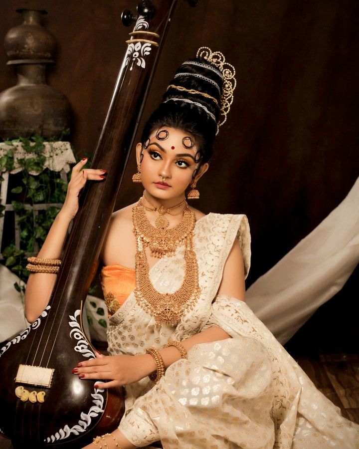 a woman sitting on the floor with a musical instrument