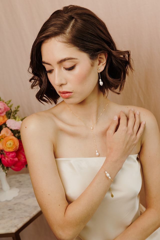 Introducing our Cosette Pearl Bracelet, a delicate and elegant piece of jewelry that is perfect for weddings or any formal occasion. This dainty gold chain bracelet features beautiful freshwater pearls that are hand wire-wrapped with a 14k yellow gold-filled chain, creating a stunning and timeless look. FEATURES Material: 14k Gold Fill, Freshwater Pearls Dimensions: 6" with a 2" extender Elegant Wire Wrapped Pearl Bracelet, Elegant Wire Wrapped Wedding Bracelets, Feminine Pearl Bracelet For Wedding, Feminine Pearl Bracelet With Charm For Wedding, Dainty Pearl Bracelet With Pearl Charm For Parties, Delicate Pearl Charm Bracelet Jewelry, Delicate Rose Gold Pearl Chain Bracelet, Dainty Pearl Drop Jewelry, Elegant 14k Gold Filled Pearl Bracelet