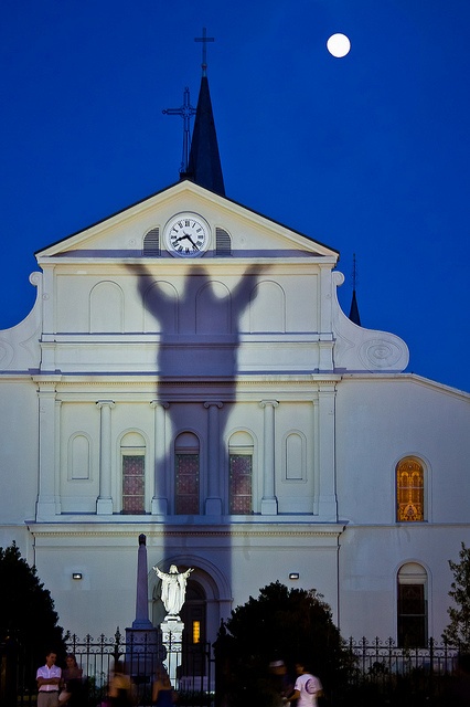 the shadow of a person standing in front of a church