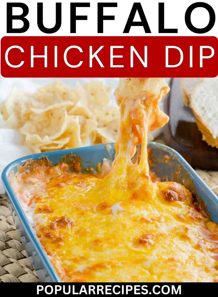 the best buffalo chicken dip recipe is in a blue casserole dish with cheese being drizzled over it