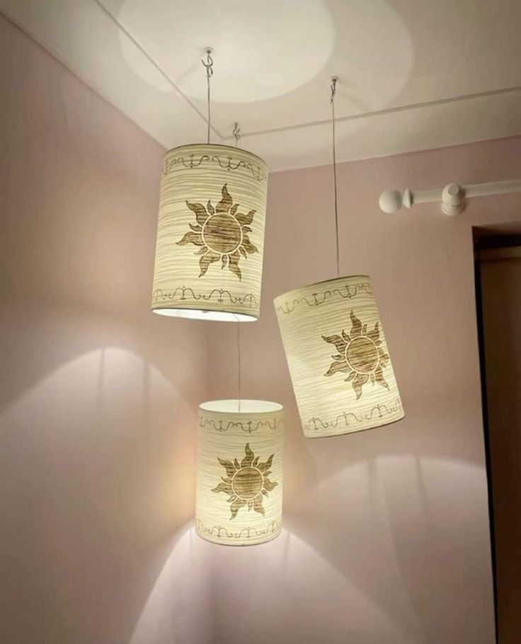 three lamps hanging from the ceiling in a room