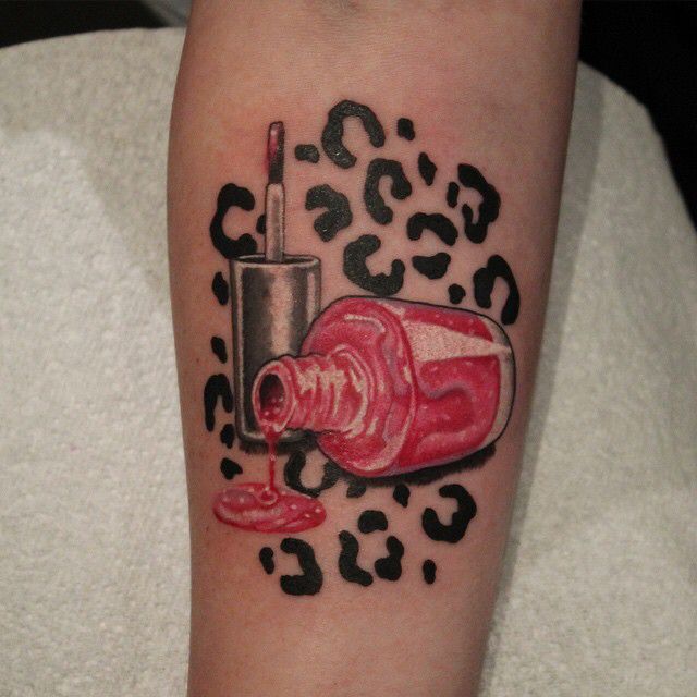 a woman's arm with a tattoo on it that has a bottle and lipstick