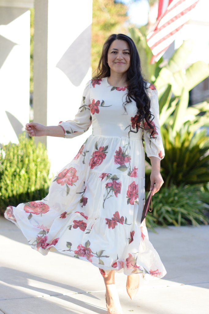 Modest Flowy Tiered Dress For Spring, Modest Tiered Dress For Garden Party, Modest Tiered Skirt Dress For Brunch, Modest Tiered Dress For Spring, White Maxi Tiered Dress For Brunch, White Maxi Length Tiered Dress For Brunch, Cream Tiered Flowy Maxi Dress, Flowy Tiered Cream Maxi Dress, Modest Flowy Maxi Dress With Tiered Skirt