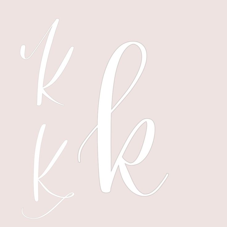 the letter k is shown in white on a light pink background with an elegant calligraphy style