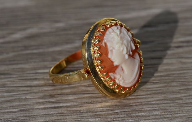 The Veena Ladies Antique Cameo Ring in 14K Yellow Gold. Crafted in 14 karat yellow gold, this ring is in excellent condition. Currently a finger size 8, this ring can be adjusted in size upon request. Each piece has been hand selected and meticulously identified and graded by a Graduate Gemologist who has been awarded a degree by the Gemological Institute of America (GIA). Please visit our Shop's About Page or our website for more information about our jewelry. Sizing for all rings is an additio Yellow Gold Cameo Ring Fine Jewelry, 14k Gold Cameo Ring Fine Jewelry, Cameo 14k Gold Rings For Anniversary, 14k Gold Cameo Rings For Anniversary, Luxury Yellow Gold Cameo Rings, Yellow Gold Cameo Rings For Gifts, Fine Jewelry Cameo Rings For Weddings, Wedding Cameo Ring In Yellow Gold, 14k Gold Cameo Rings For Wedding