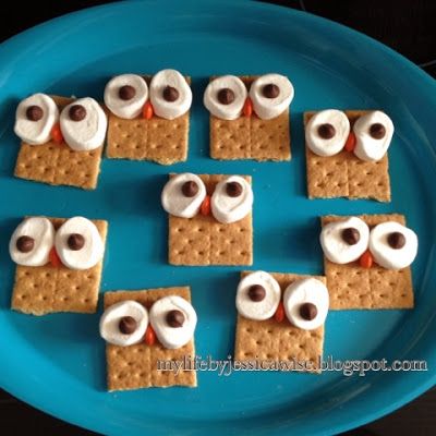 crackers with marshmallows and googly eyes are on a blue plate