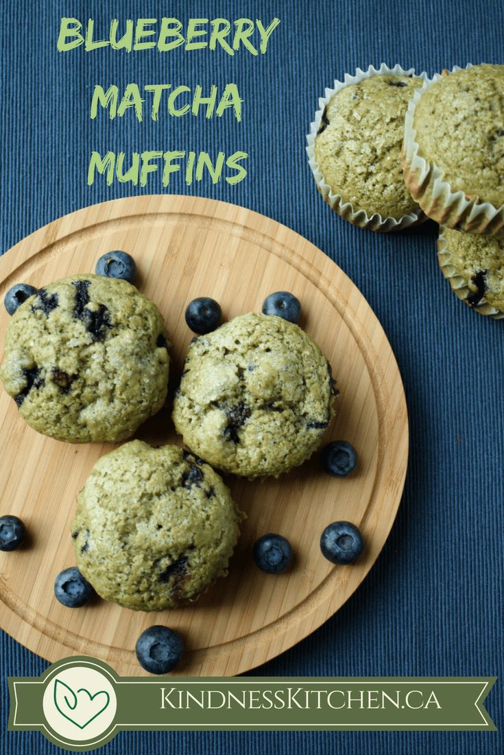 blueberry matcha muffins on a wooden plate next to some muffins