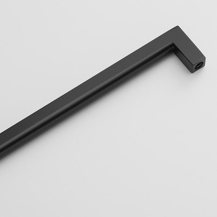 a black metal handle on a white surface