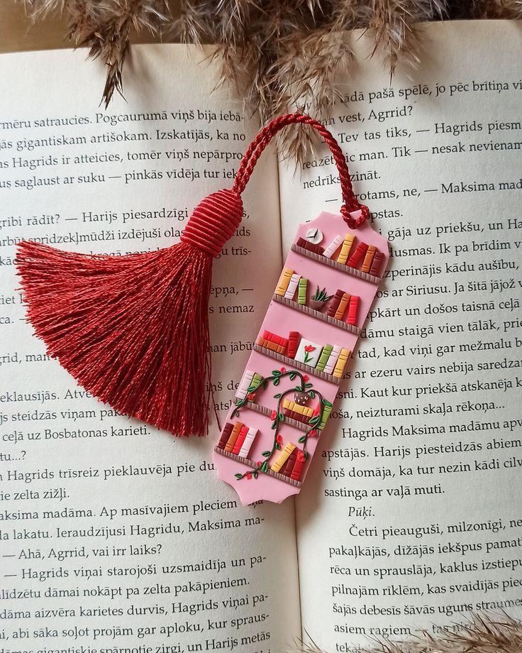 an open book with a tassel hanging from it