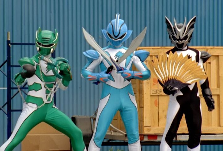 three men in power rangers costumes standing next to each other