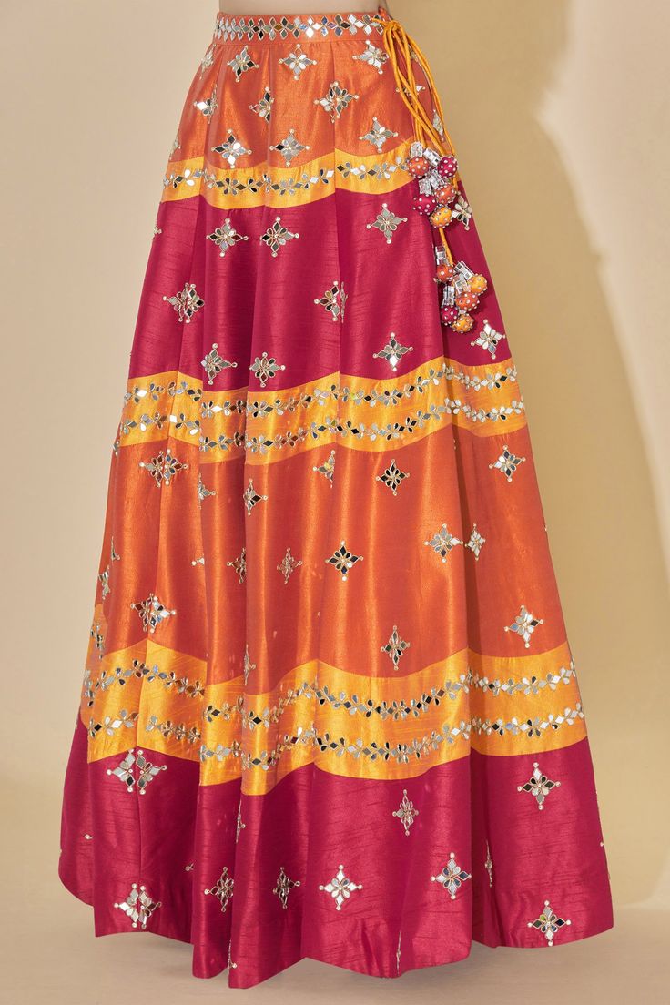 Orange high-waist lehenga with mirror embellished motifs. Comes with blouse and sheer dupatta.
Components: 3
Fabric: Dupion Raw Silk
Neckline: Scoop
Sleeve Length: Sleeveless
Color: Orange
Embellishment
Stone and mirror embellished motifs on blouse
Deep back on blouse with tassel tie-up detail
Printed motifs on dupatta
Mirror motifs on dupatta
Mirror embellished motifs on dupatta border
Side tassel tie-up detail on lehenga
Closure:
Blouse: Concealed side zip placket
Lehenga: Concealed side zip p Floor-length Palazzo Set With Dori Work For Festivals, Navratri Reception Palazzo Set With Gota Work, Navratri Party Palazzo Set With Cutdana, Festive Floor-length Palazzo Set With Dori Work, Navratri Cutdana Palazzo Set For Party, Festival Party Anarkali Set With Cutdana, Floor-length Embellished Multicolor Sharara, Floor-length Multicolor Embellished Sharara, Multicolor Embellished Floor-length Sharara