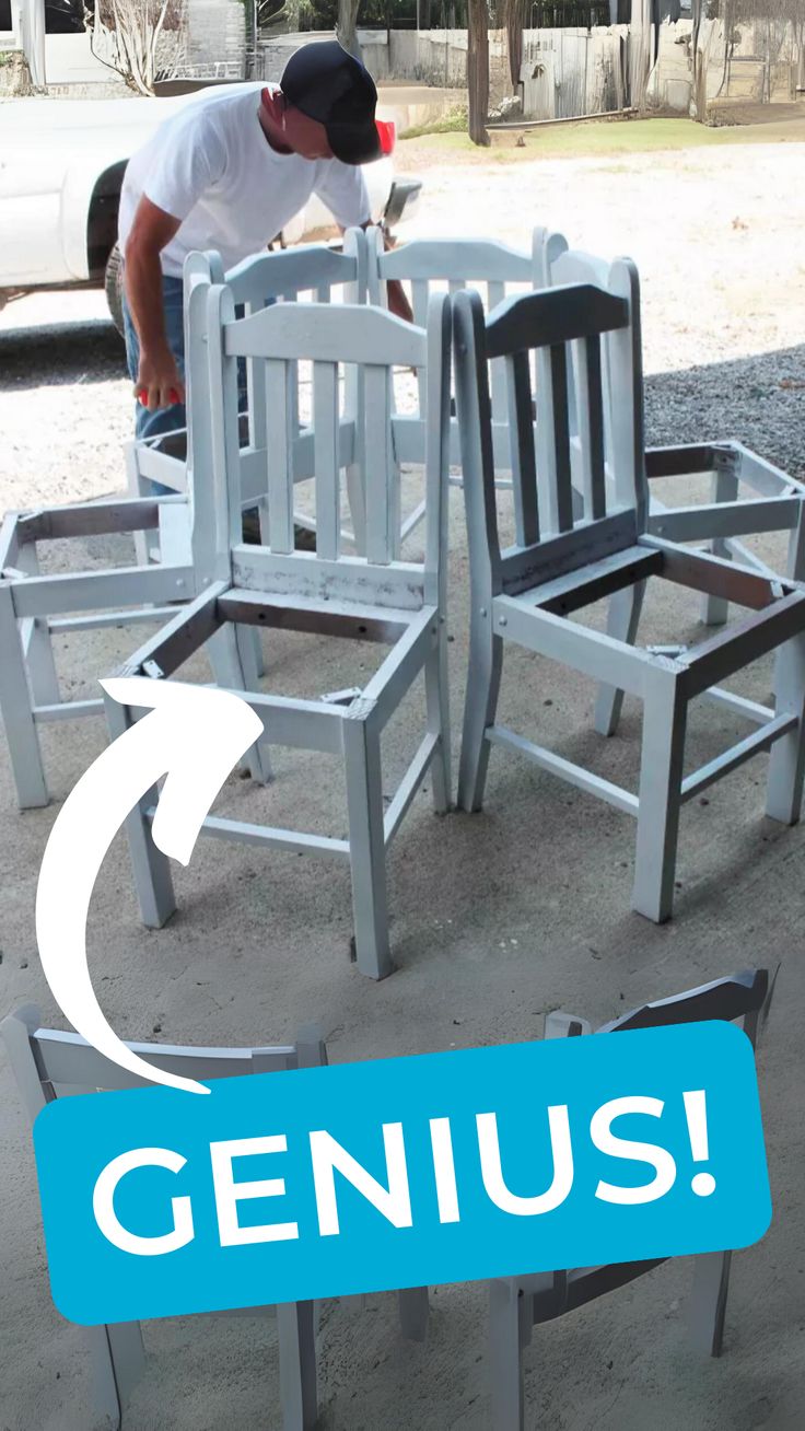 a man bending over to pick up some chairs