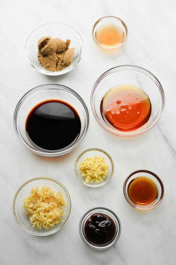 an assortment of sauces and condiments in glass bowls