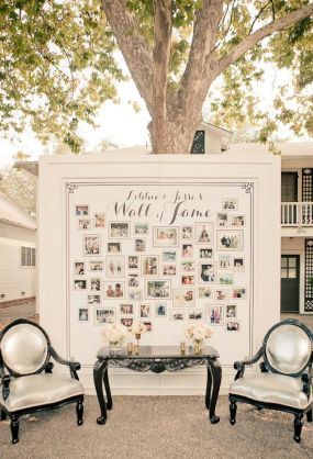 two chairs sitting next to each other in front of a large sign with pictures on it