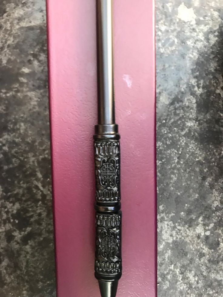 a pen sitting on top of a pink box