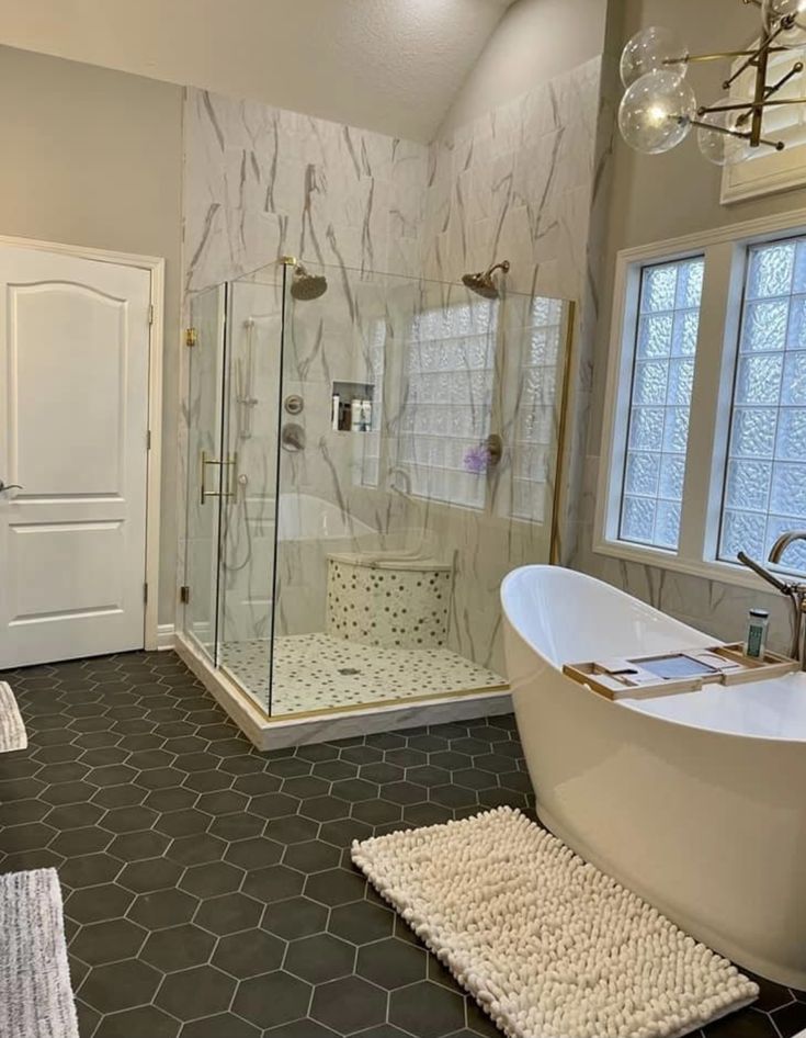 a bathroom with a large tub and walk in shower