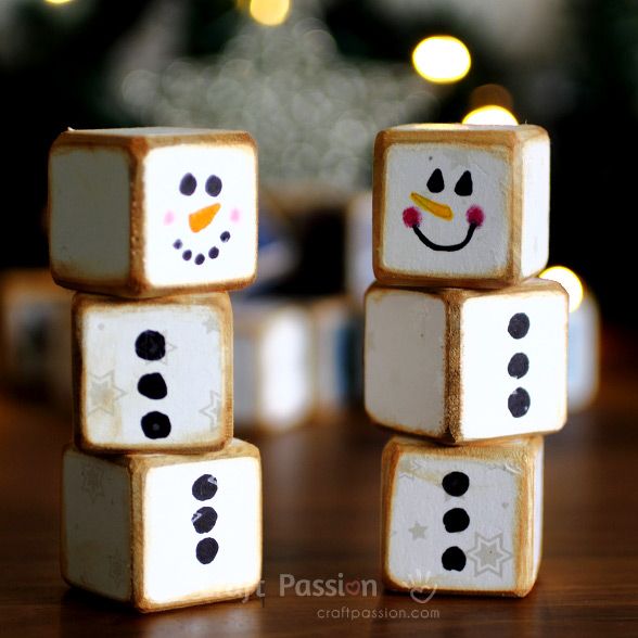 snowmen made out of marshmallows sitting on top of a wooden table