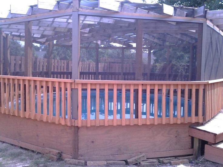 a large wooden deck with a pool in the middle and a gazebo above it