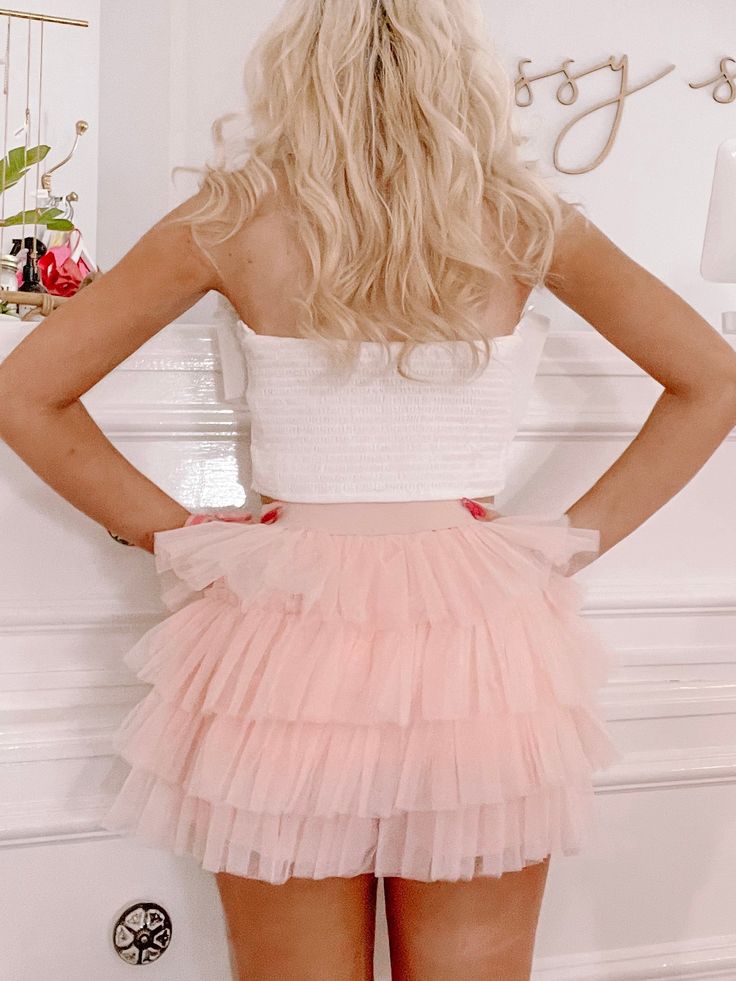 The Trixie Tulle Skirt from Sassy Shortcake is a tiered ruffle bright pink tulle skort. She features an elastic waistband. Lined. Model wearing a size small. content: 100% polyester Tiered Mini Skirt For Spring Party, Tiered Fitted Mini Skirt For Party, Fitted Tiered Mini Skirt In Feminine Style, Party Tiered Mini Skirt With Ruffles, Tiered Mini Skirt With Ruffle Hem For Party, Tiered Mini Skirt For Summer Parties, Flirty Fitted Tiered Bottoms, Pink Tiered Bottoms For Summer, Chic Pink Tiered Bottoms