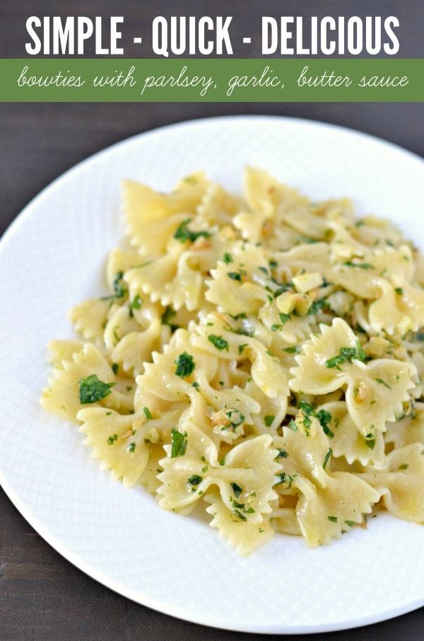 a white plate topped with pasta and parsley