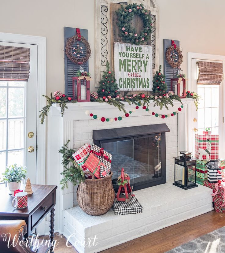 a fireplace decorated for christmas with stockings and presents on the mantel, along with other holiday decorations