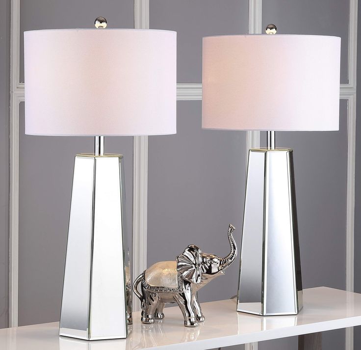 two lamps on a table with an elephant figurine