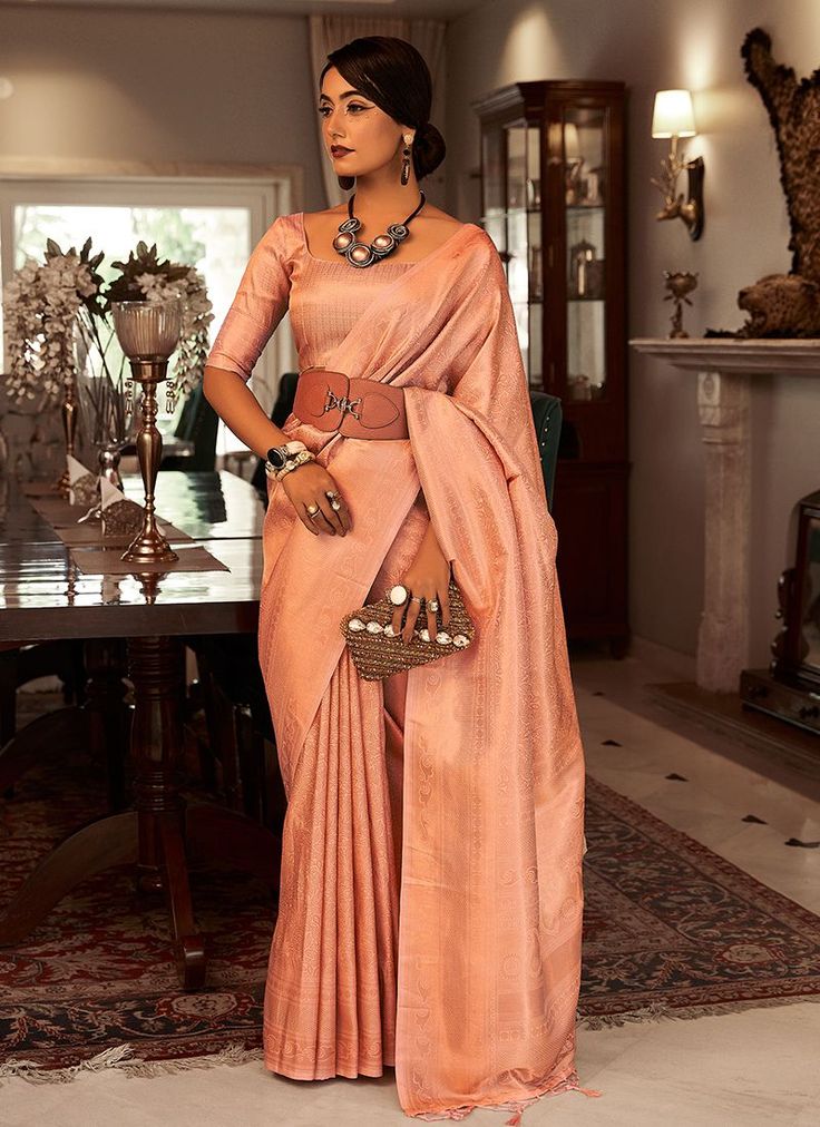 Peach Satin Silk Party Wear Kanchivaram Saree SAMBHAVISILK 152004  Desc:  Description  Peach color satin based kanchivaram silk saree .The blouse comes as unstitched material.  The smooth texture is created by a combination of the high quality silk yarns used to make the fabric and the way the fabric is woven.Satin silk is typically made fromt he long staple silk fibres which are silk fibres that are longer than the average silk fibre.This results in a fabric that is smooth and silky to the touc Kanchivaram Saree, Kanchivaram Silk Saree, Peach Saree, Orange Saree, Salwar Dress, Dress Salwar Kameez, Kanjivaram Silk Saree, Wedding Silk Saree, Lehenga Collection