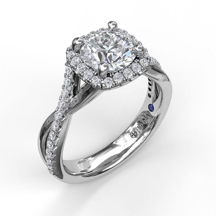 a white gold ring with a diamond center