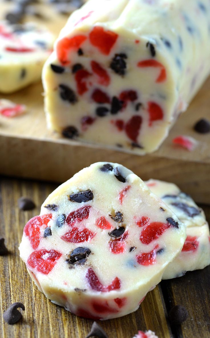 two pieces of white chocolate with red and black hearts on them next to a cutting board