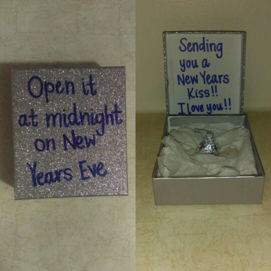 an open box with a ring in it next to a new year's eve sign